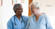 Patient and caregiver smiling at each other