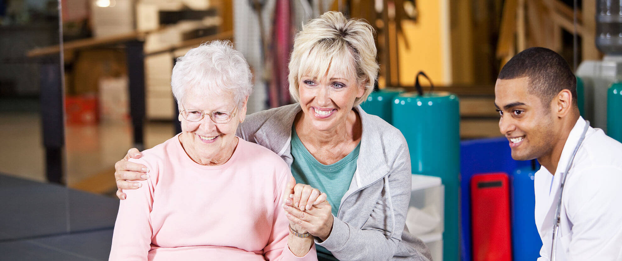 Patient family and caregiver watch physical therapy